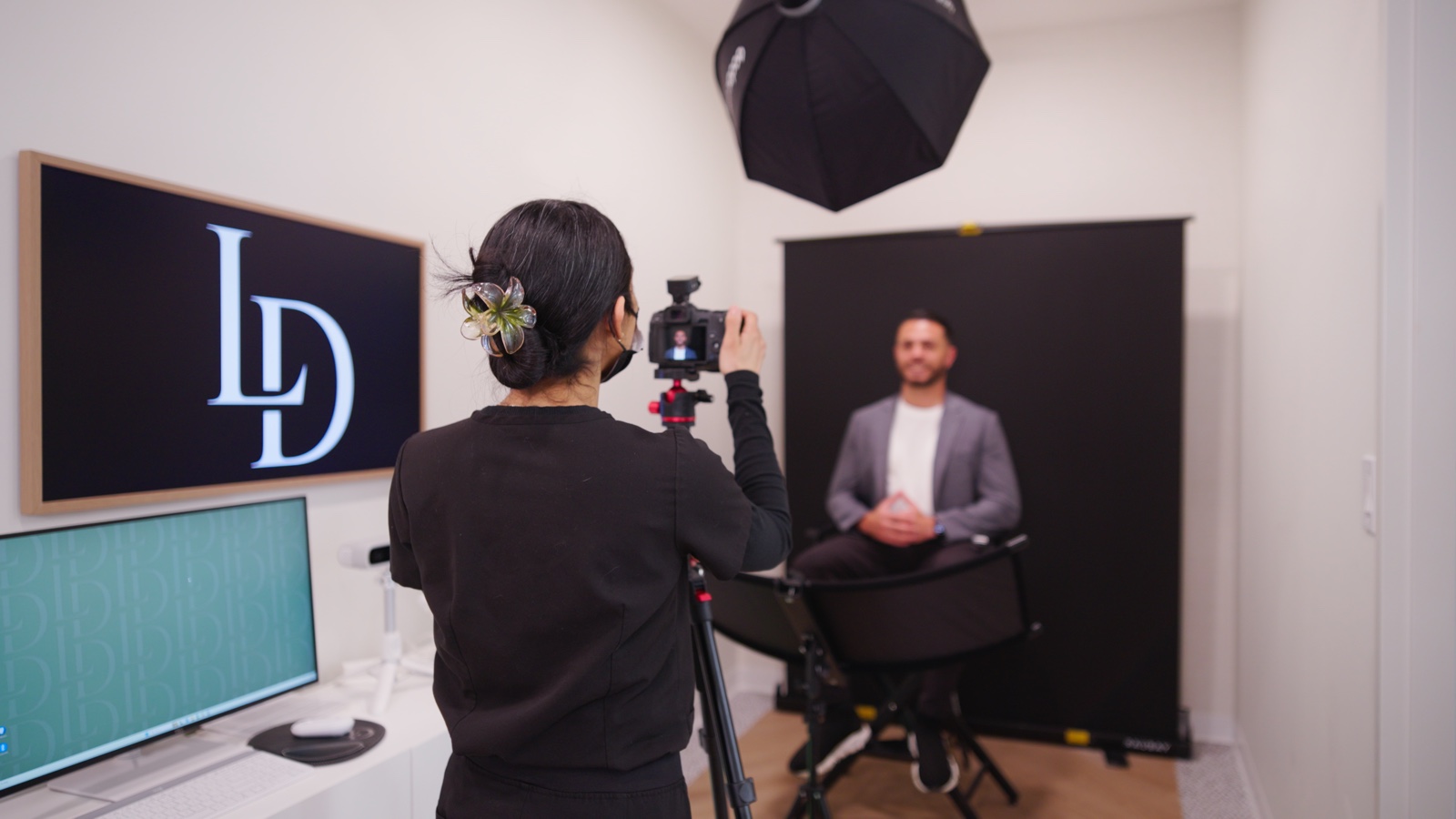 Limitless Dental in-house content studio with LD-branded backdrop and tripod setup