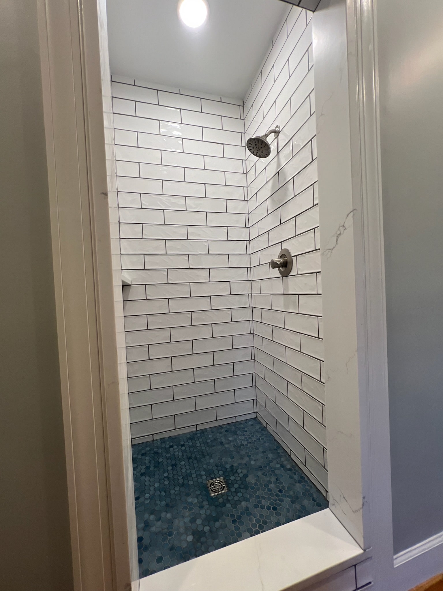 a shower with a tile floor