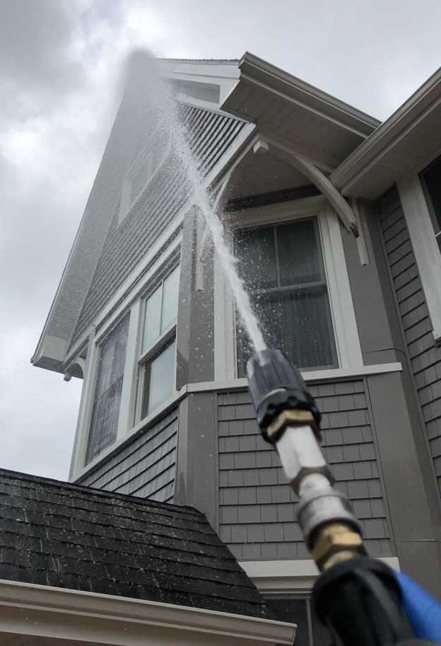 a water spraying from a hose on a house