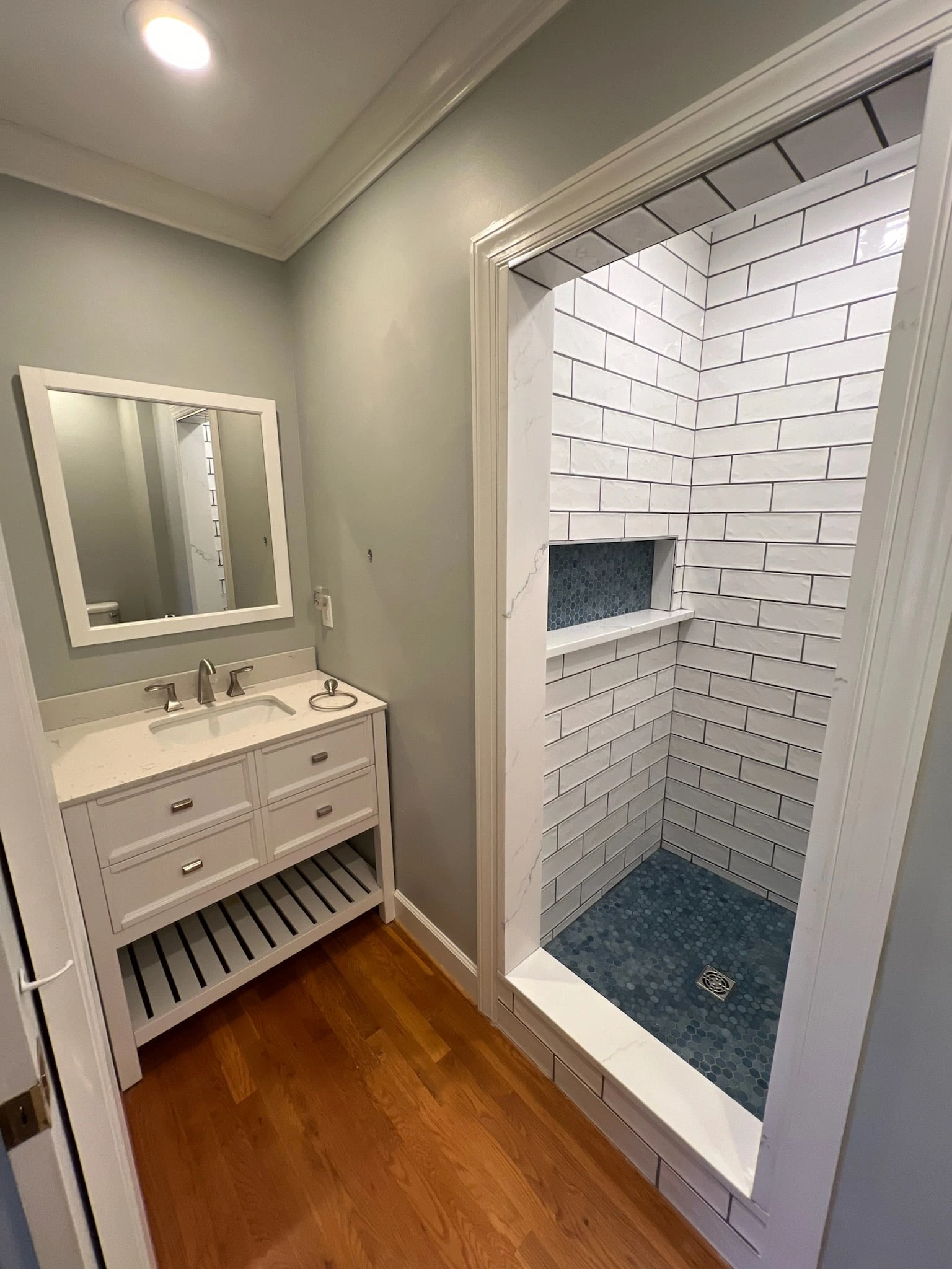 a bathroom with a shower and a mirror