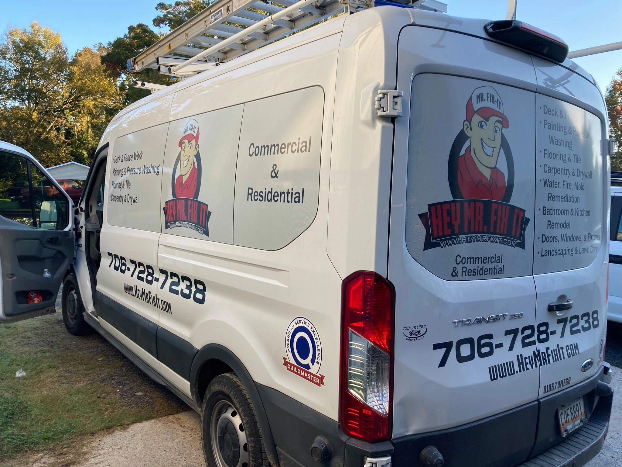 a white van with a ladder on top