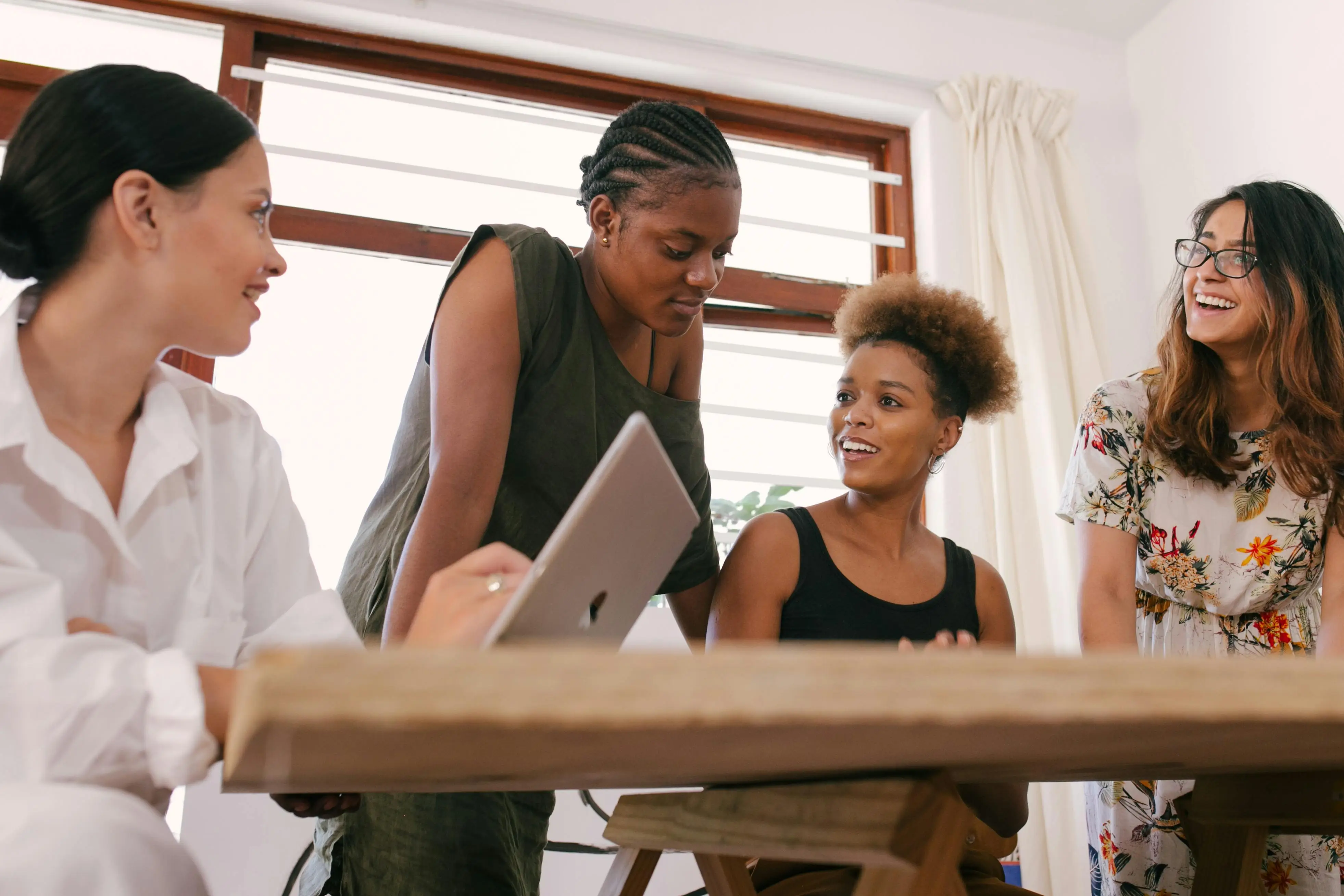 Women entrepreneurs working together in Frequency First Business community
