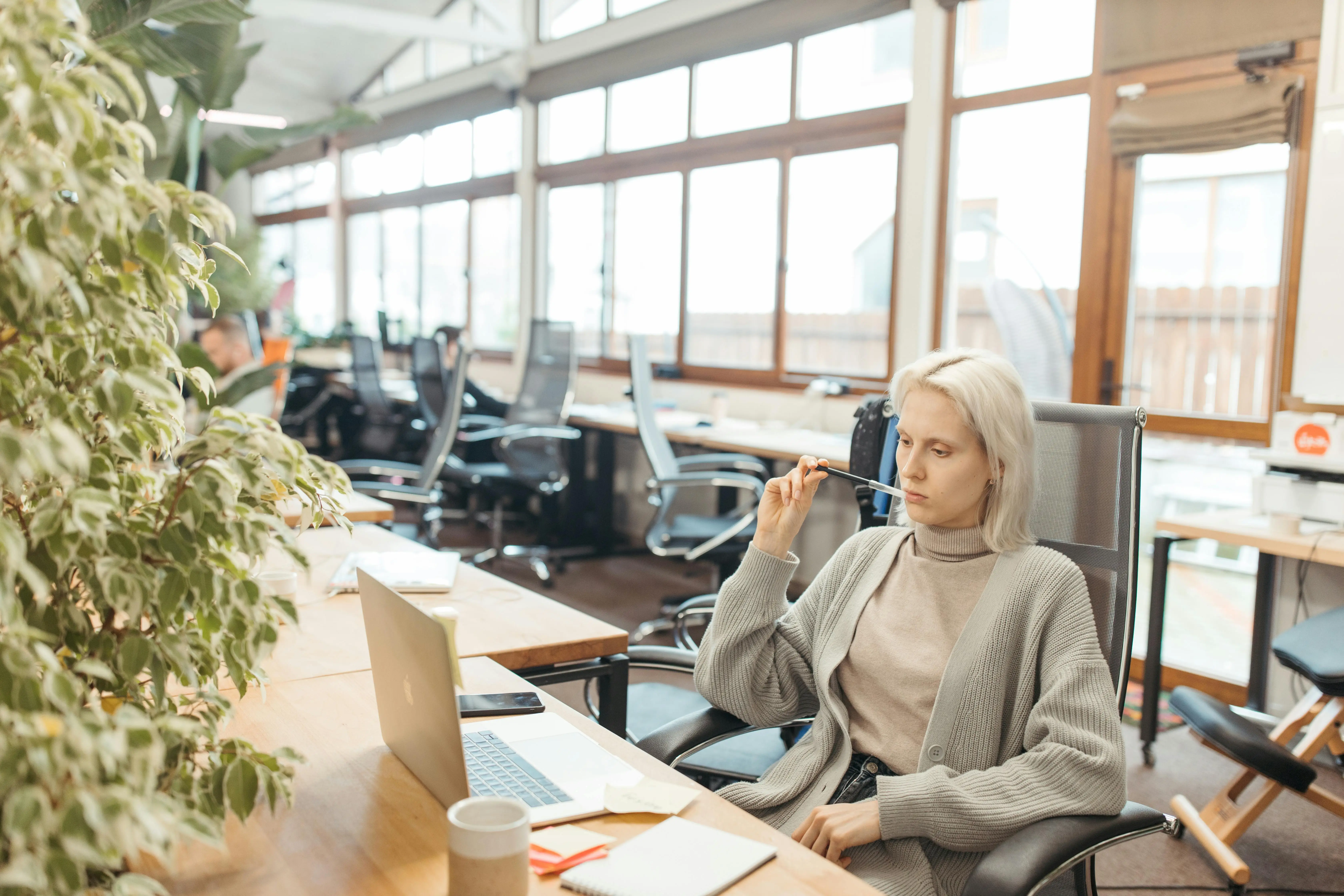 Woman entrepreneur pausing at her desk, nervous system and business growth