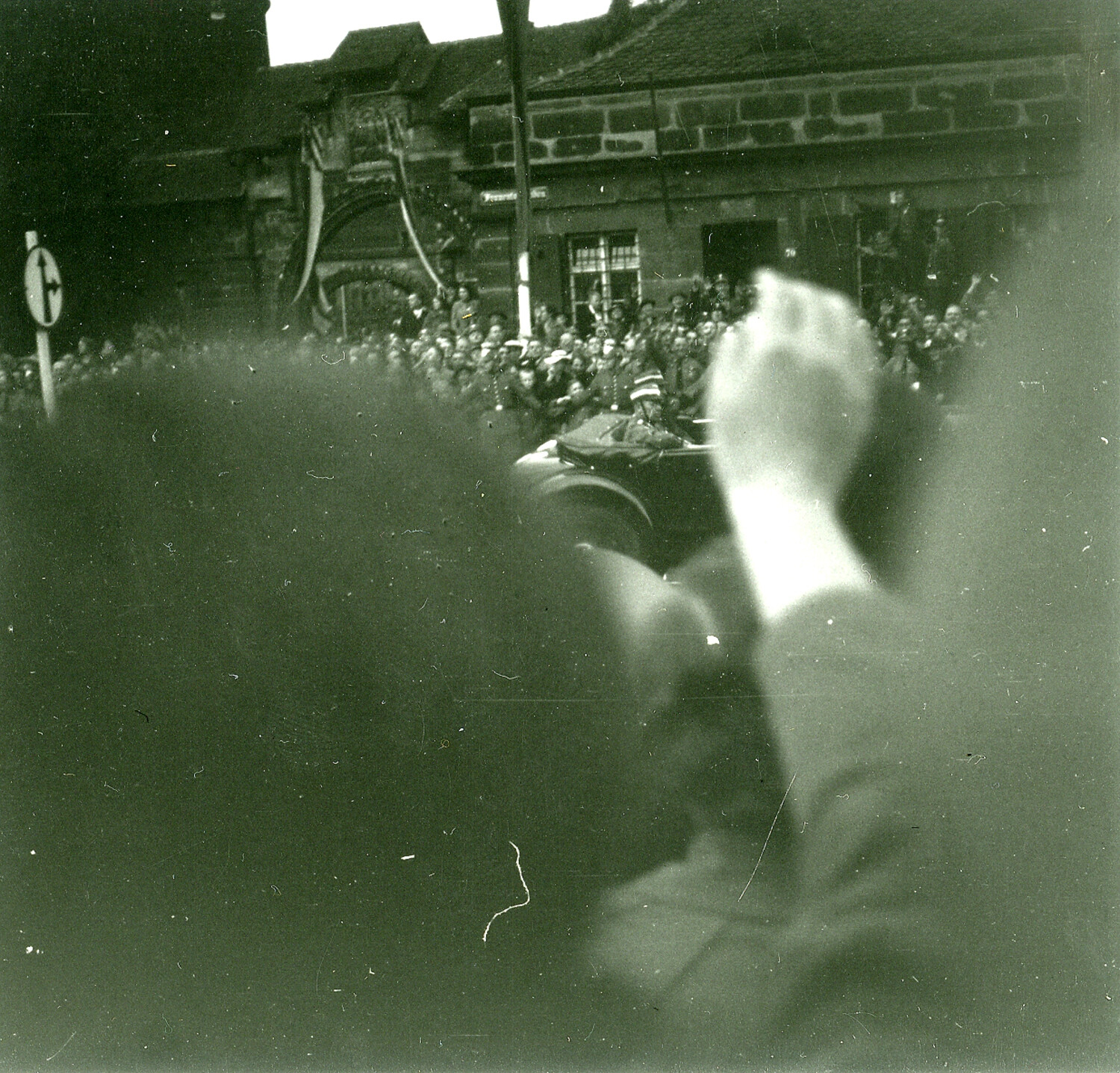 Crowd Along a Nuremberg Street, Viewed Past a Photographer's Raised Hand (WWII-Era, c. 1945)