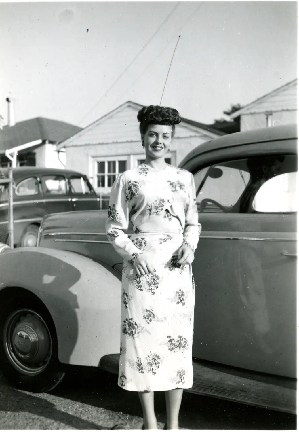 Portrait of a Woman in Floral Dress Beside Parked Automobiles, Mid-1940s Home Front
