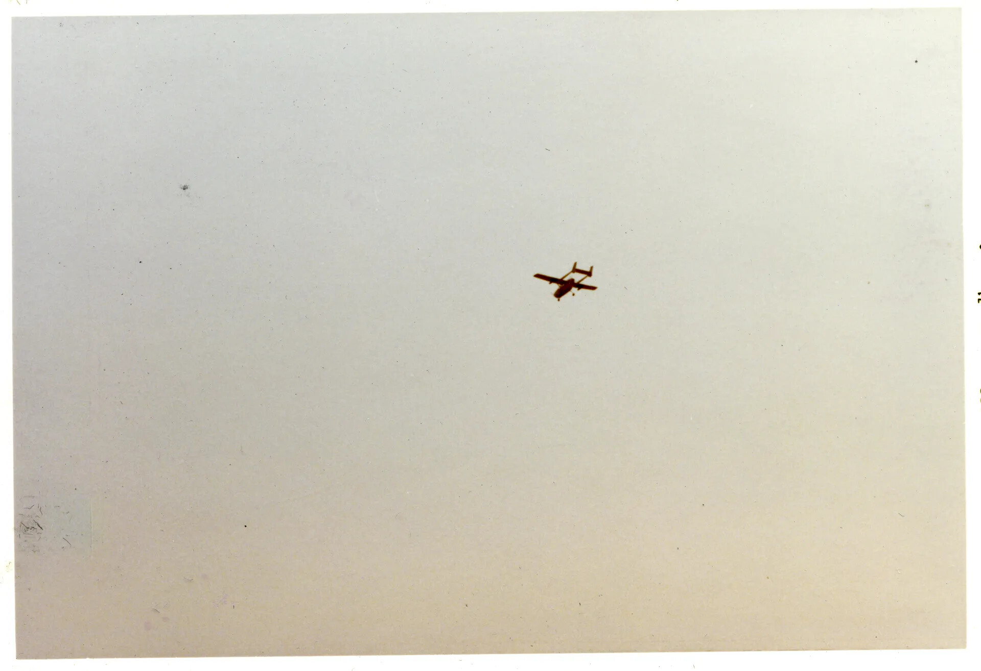 Distant Twin-Boom Aircraft (Likely OV-10 Bronco) Over Nakhon Phanom RTAFB, Vietnam War Era