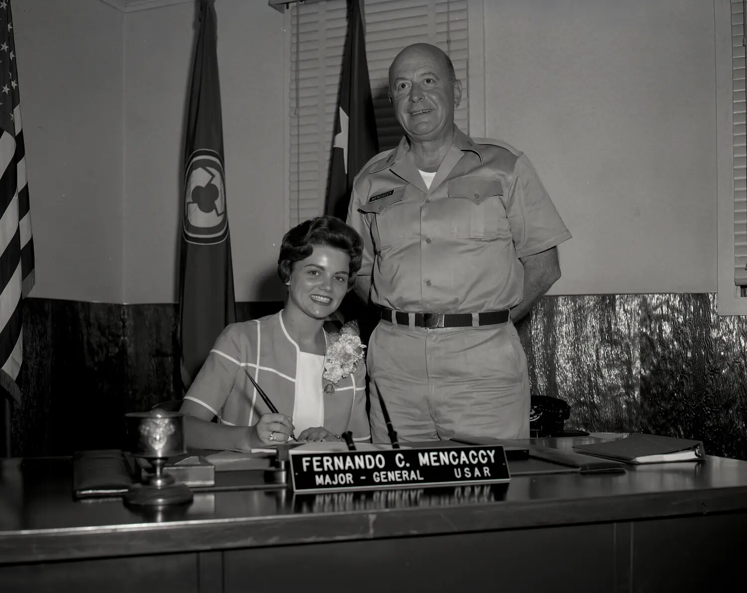 Major General Fernando C. Mencaccy, USAR, with Young Woman Signing Document in Office, circa early 1960s
