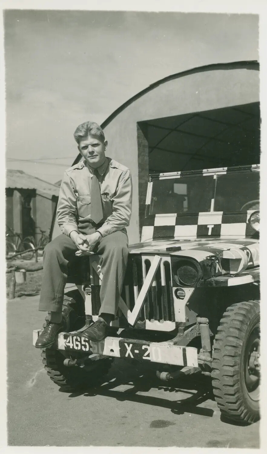 Capt. Barney Glotler, Tower Control Officer, 392nd Bombardment Group, Seated on Marked Jeep