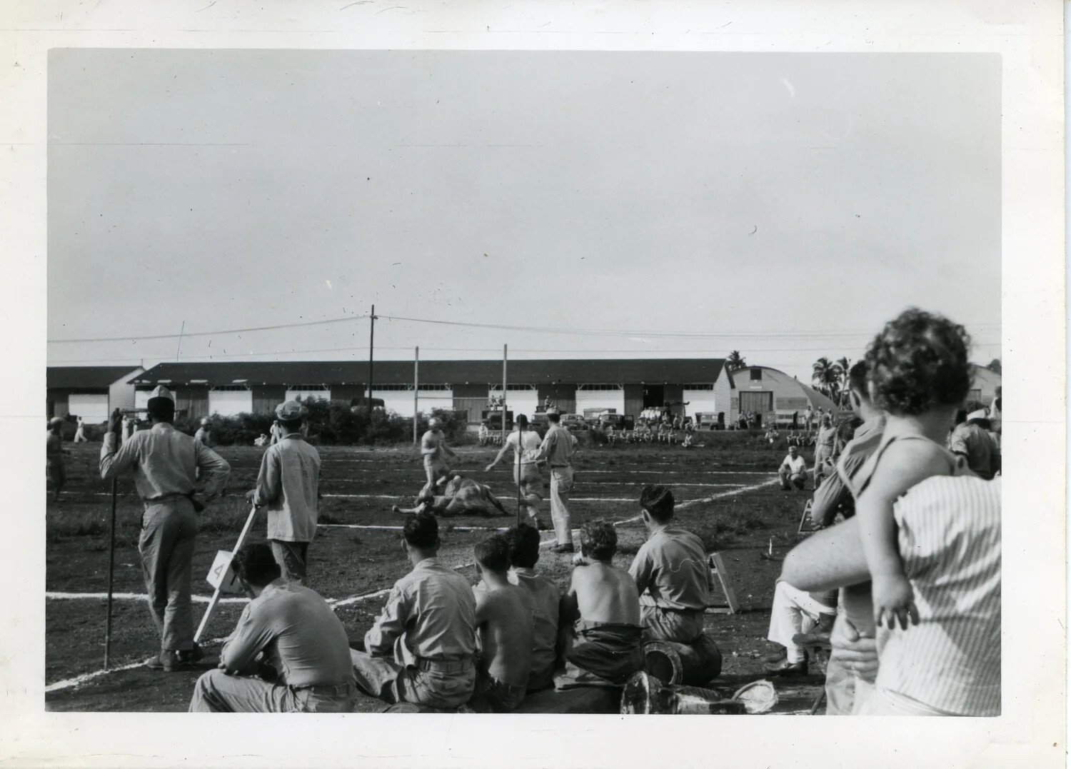 Servicemen Watching a Field Athletic Event, NAS Agana, Guam