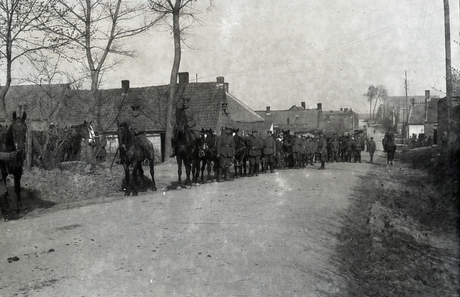 Mounted German Officers Leading Infantry Column Through Village Street, WWI