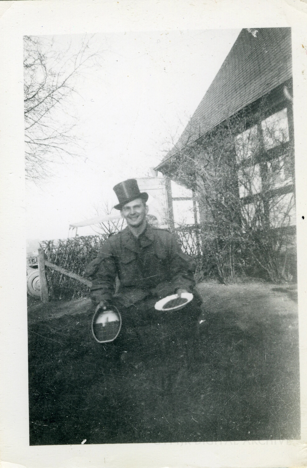 Soldier Wearing Civilian Top Hat, Rural European Farmhouse, WWII Era