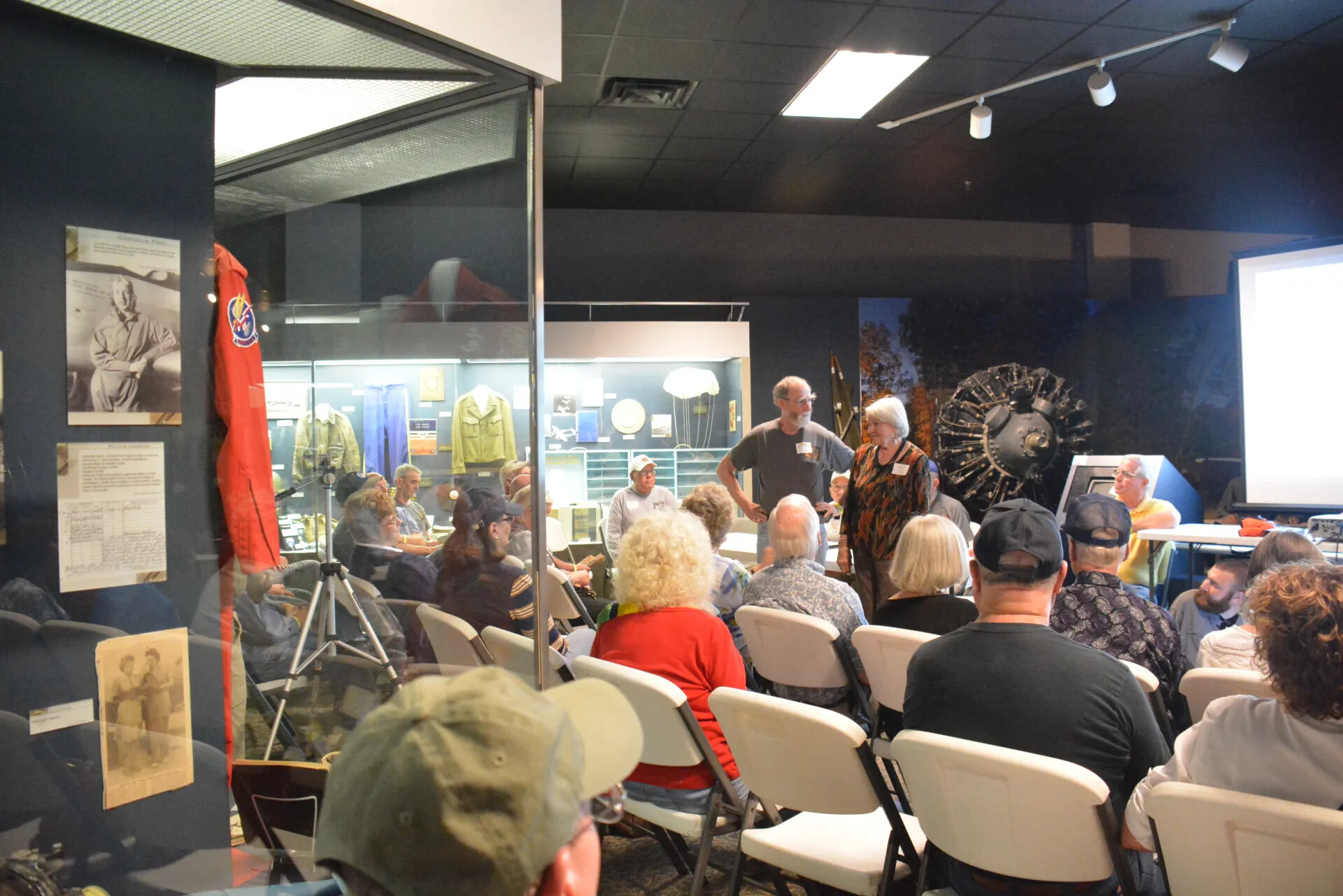 Exhibit Case Foreground with Reunion Attendees, Tennessee Museum of Aviation