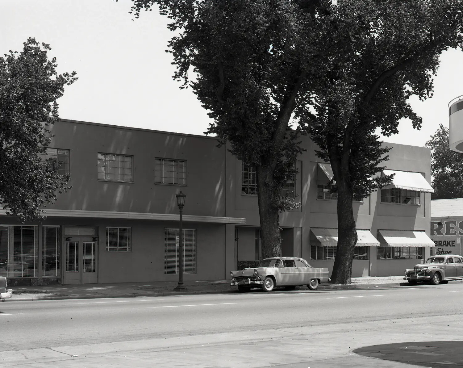 Commercial Street Scene, Two-Story Stucco Building with Period Automobiles, California, c. 1955-1958