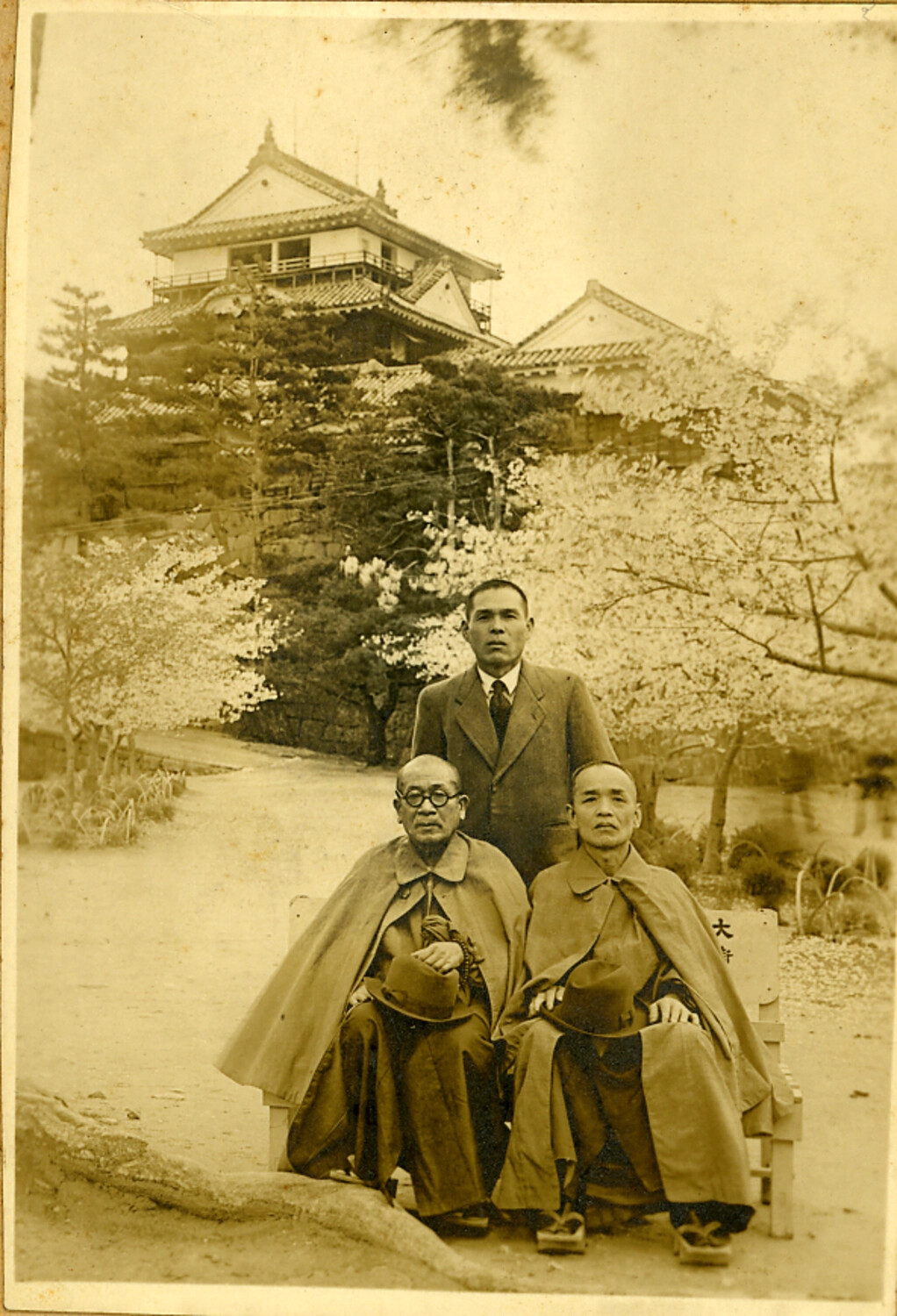 Three Generations of a Japanese Family Posed Before a Castle Keep During Cherry Blossom Season, c. 1930s-1940s