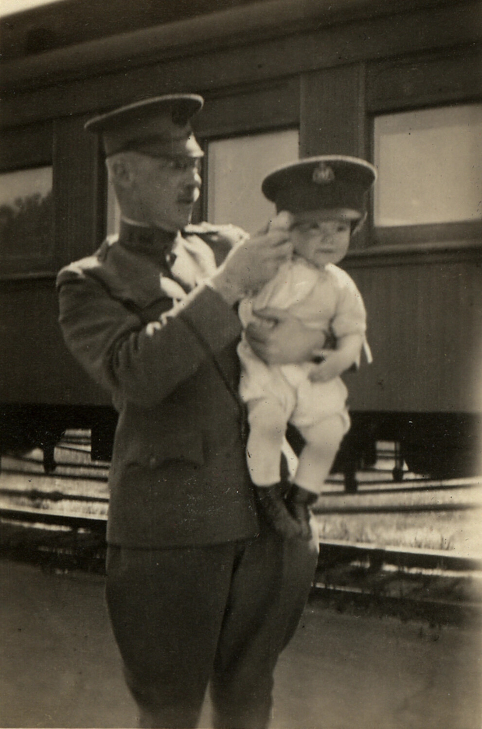 Soldier Holding Child at Train Platform, WWI Era