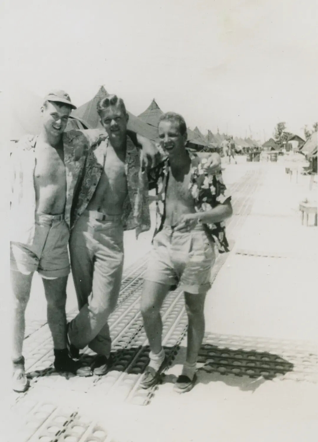 Three Servicemen in Floral Liberty Shirts on Marston Matting Airstrip, Pacific Theater, WWII
