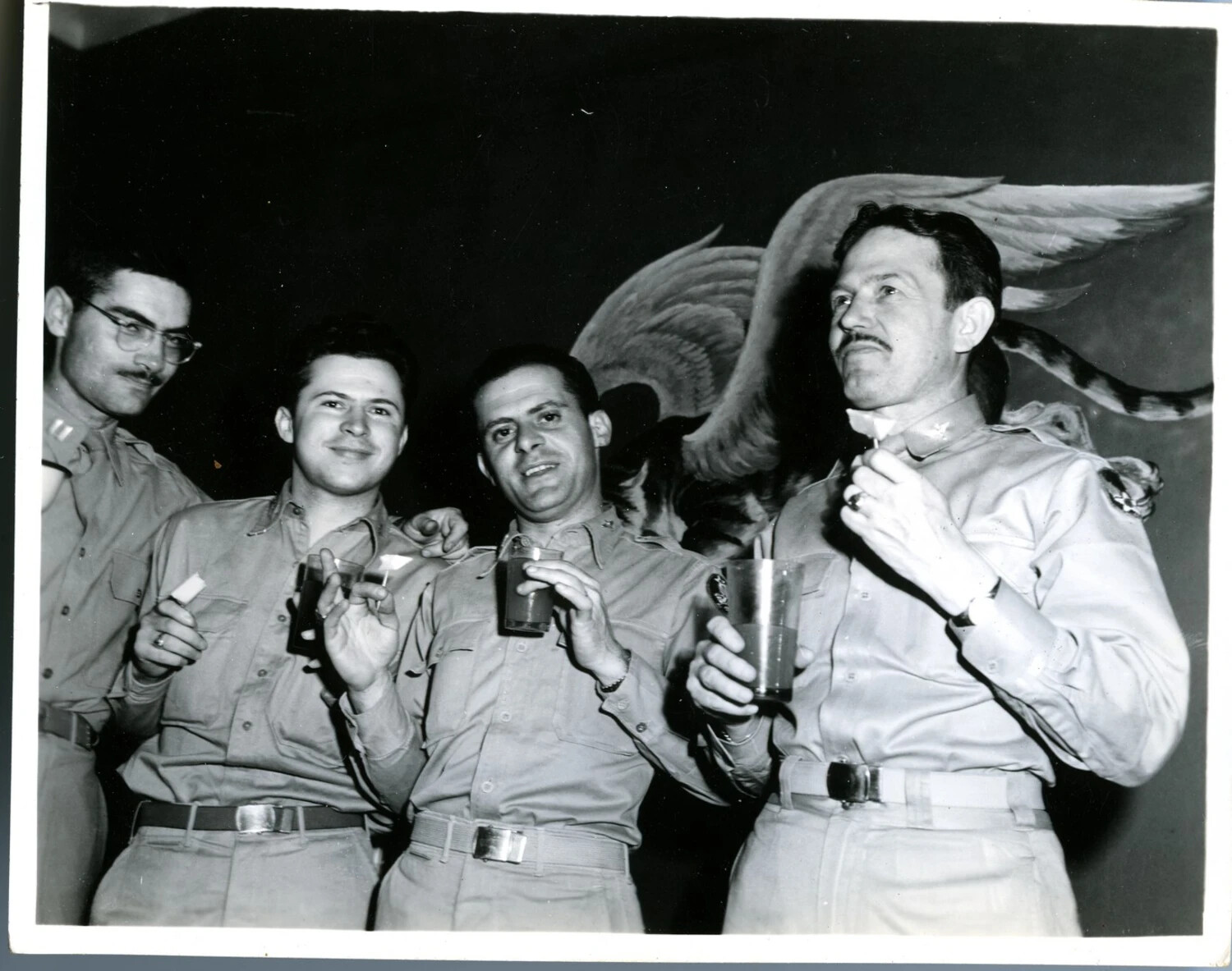 Officers Celebrating with Drinks Beneath Winged Tiger Mural, CBI Theater, World War II