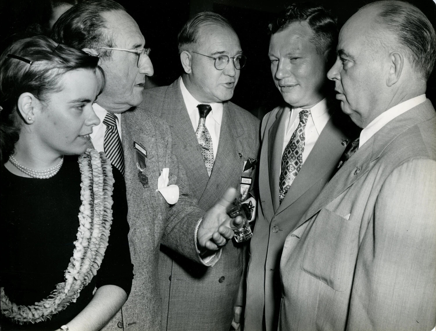 Group Conversation with Woman Wearing Shell Lei at Veterans' Convention Reception, Late 1940s