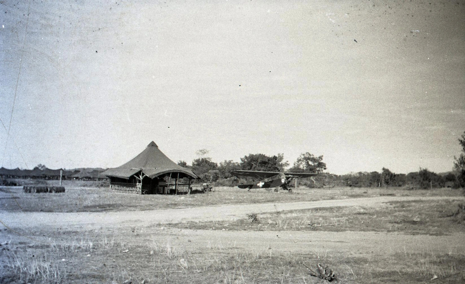 U.S. Army Liaison Aircraft and Field Tent at a Forward Airstrip, Luzon, Philippines, WWII