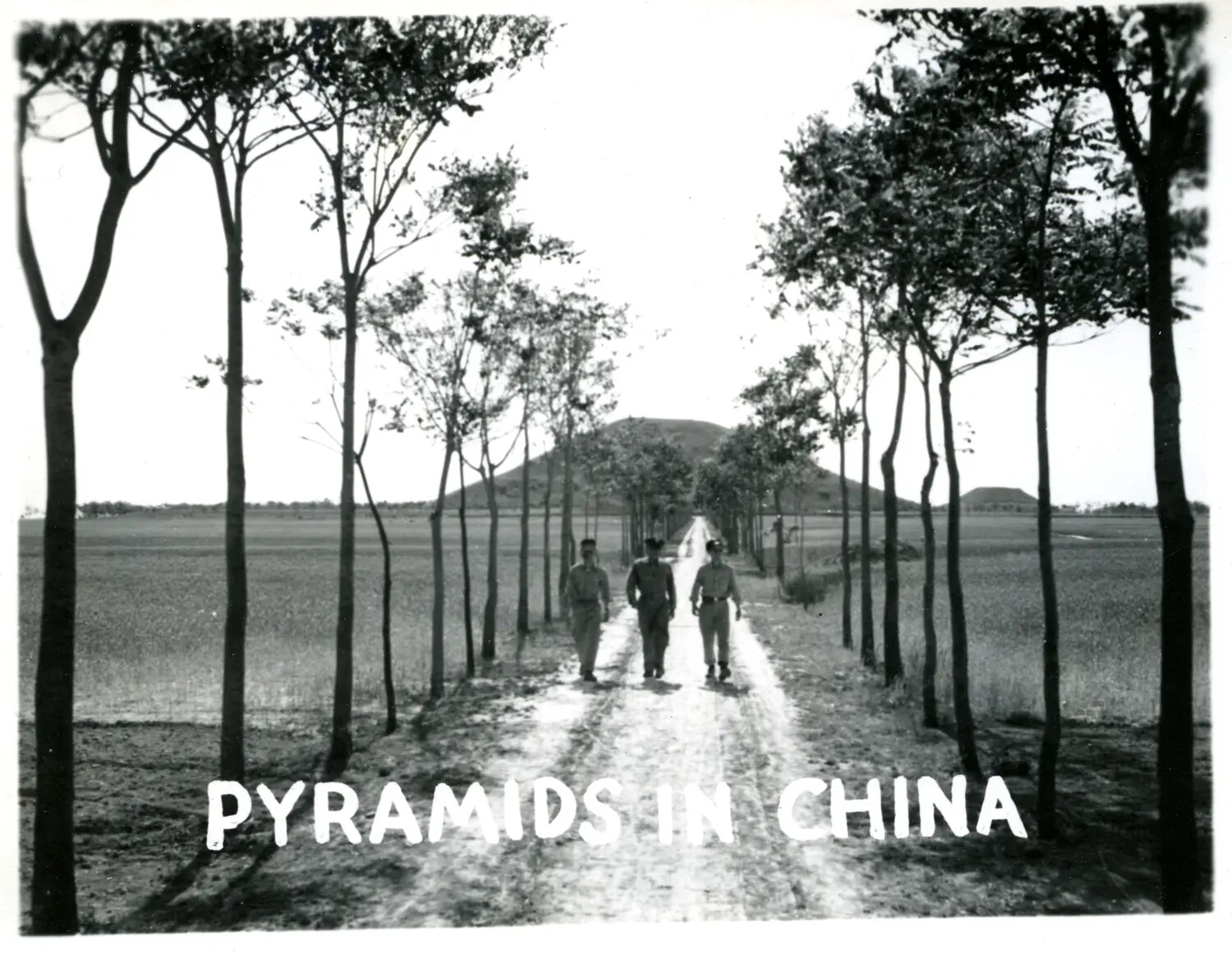 "Pyramids in China" — Servicemen Walking a Tree-Lined Road Past Earthen Mounds, CBI Theater