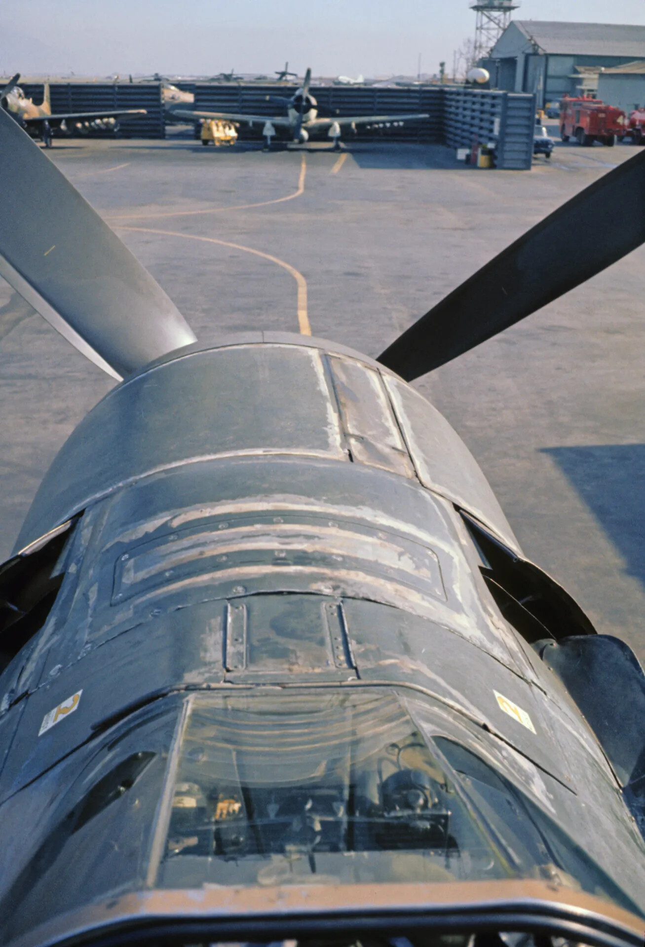 Close-Up View Along Fuselage of Parked A-1 Skyraider on Flight Line, Vietnam War Era