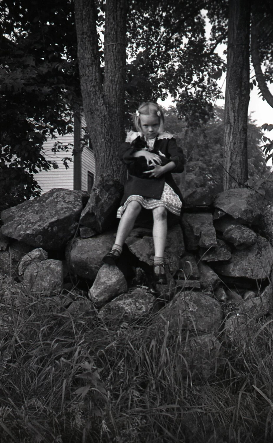 Girl Holding Cat on Fieldstone Wall, Mid-20th Century