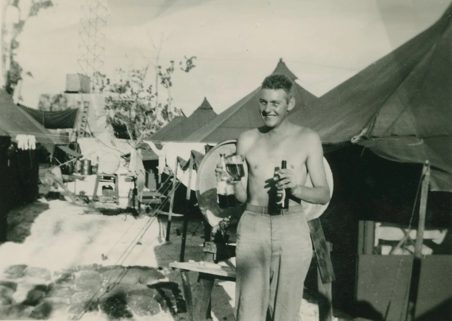 Serviceman at Tent Camp with Beverages, WWII Personal Photo Album (McAleer Collection)