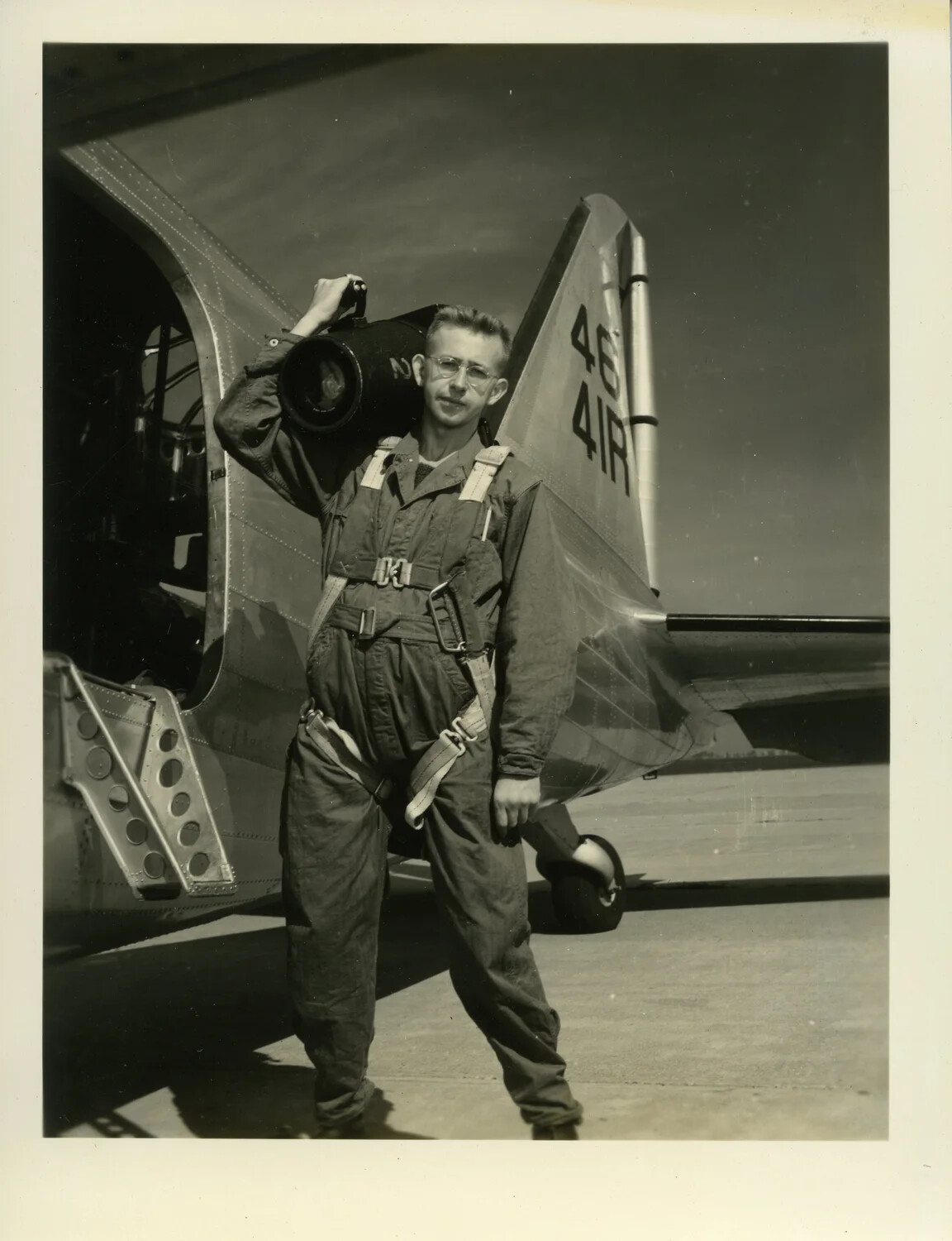 Airman with Aerial Camera Case Beside Aircraft Tail, Camera Test Photograph