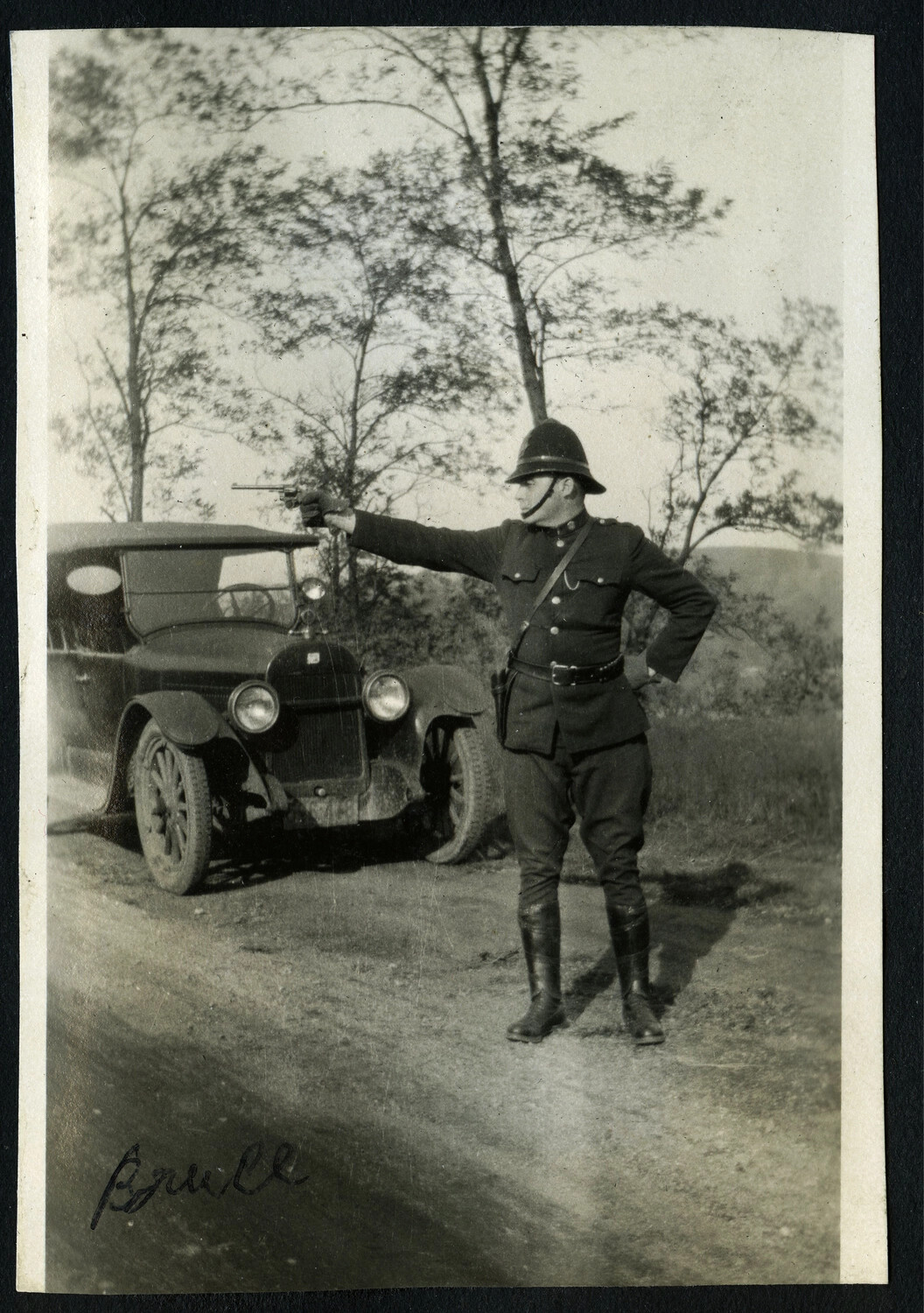 New York-Area Police Officer in Firearms Stance Beside a Touring Automobile, 1920s