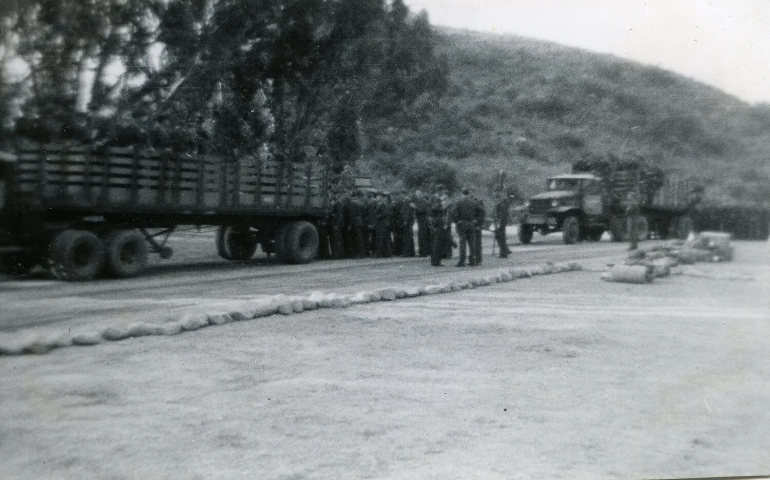 Marines and Camouflaged Supply Trucks at a Pacific Airbase, VMF-214 Album, 1945