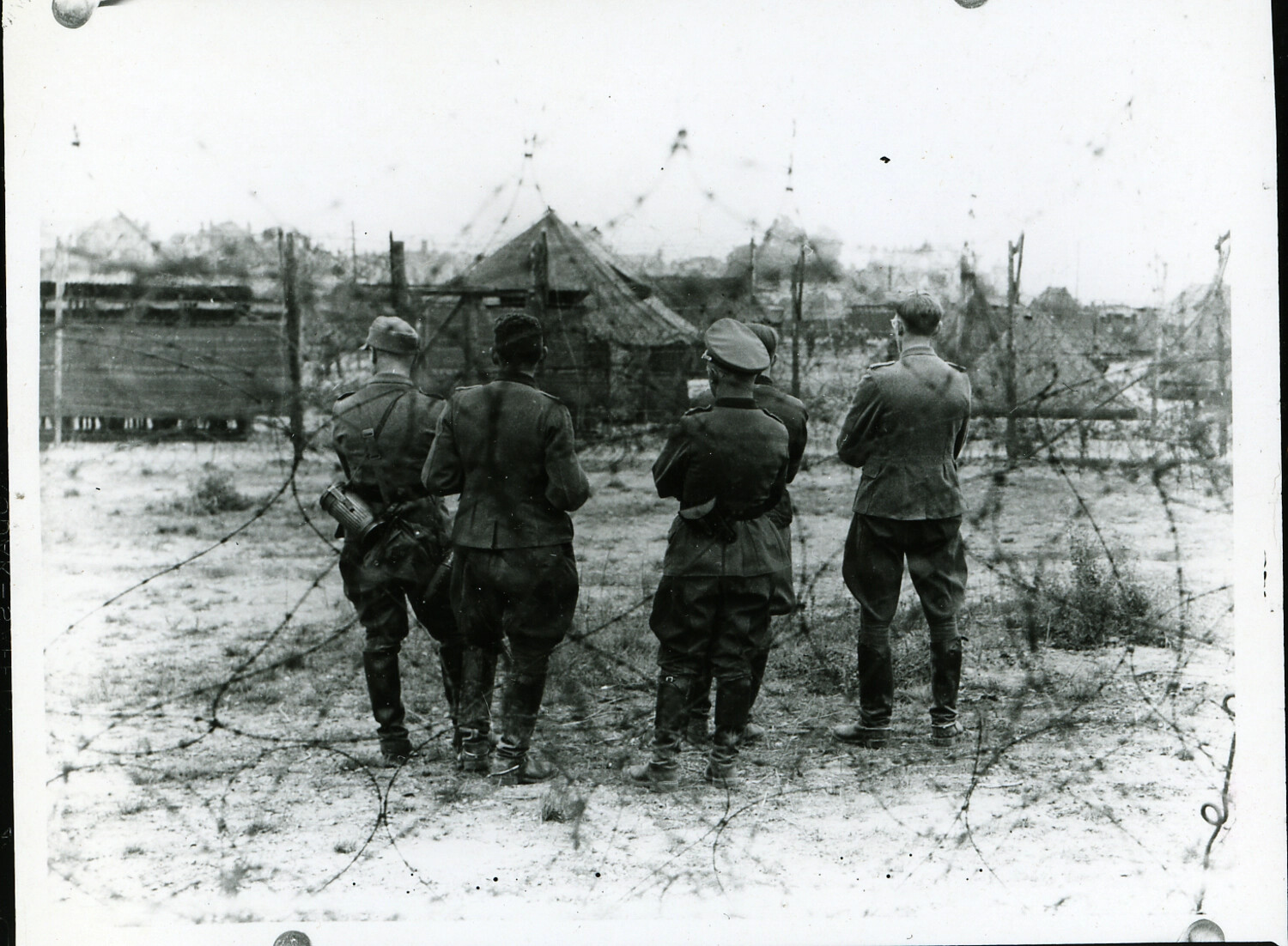 German Officer Prisoners of War Standing Within a Barbed-Wire Enclosure, World War II European Theater