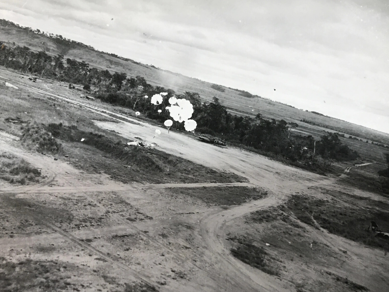 Parafrag Bomb Cluster Descending Near Airfield Perimeter Road