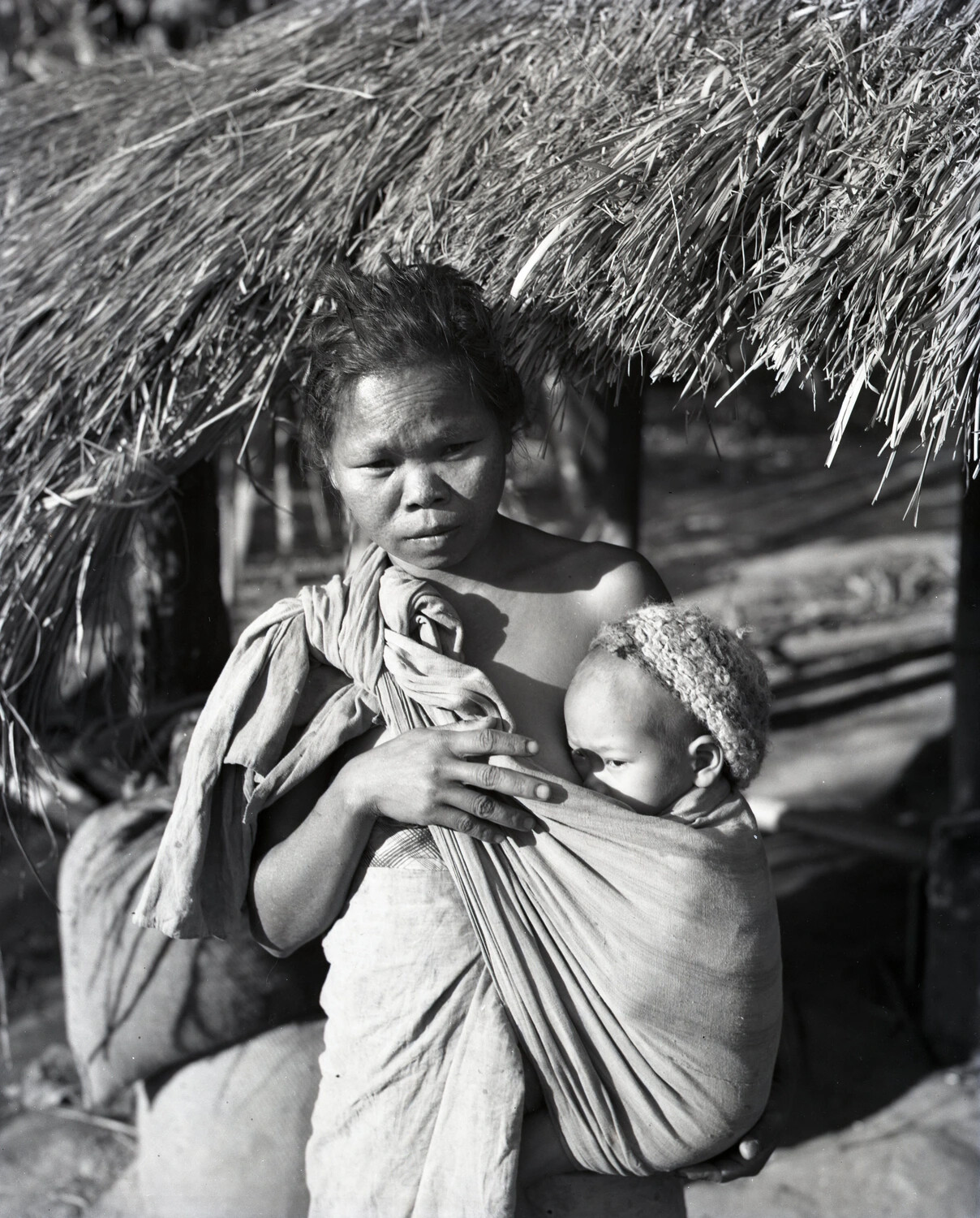 Portrait of a Woman and Infant Beneath a Thatched Roof, China-Burma-India Theater