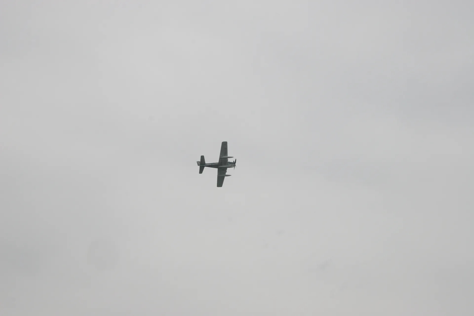 Aircraft Flyby Silhouette Against Overcast Sky