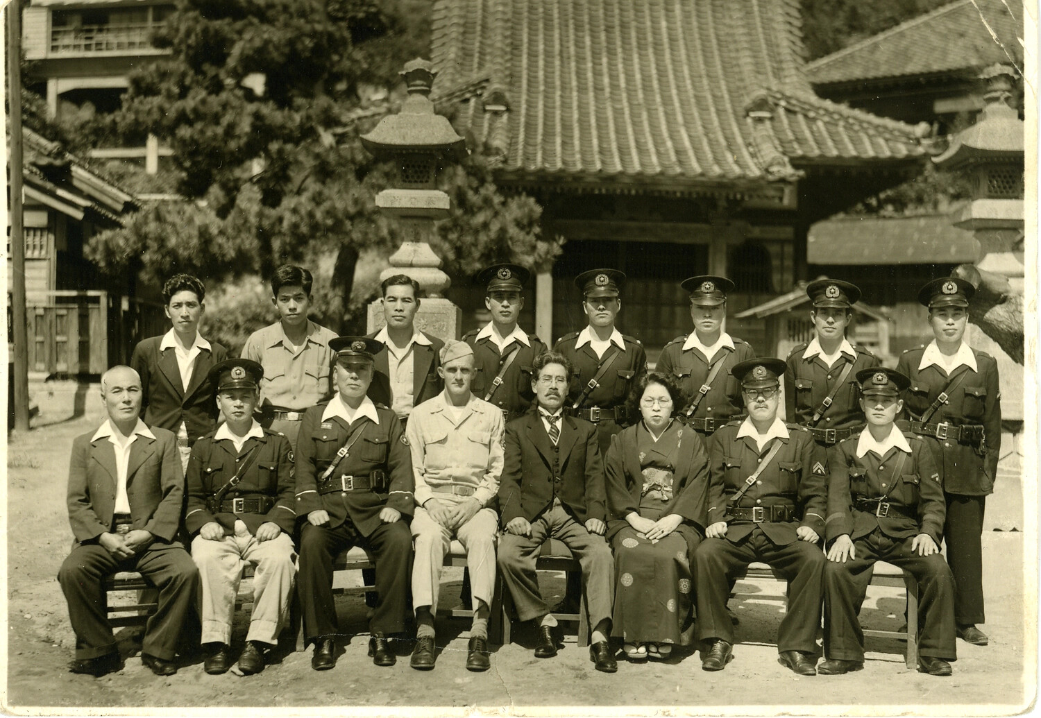 Group Portrait with Western Officer and Uniformed East Asian Personnel at a Temple, WWII Era