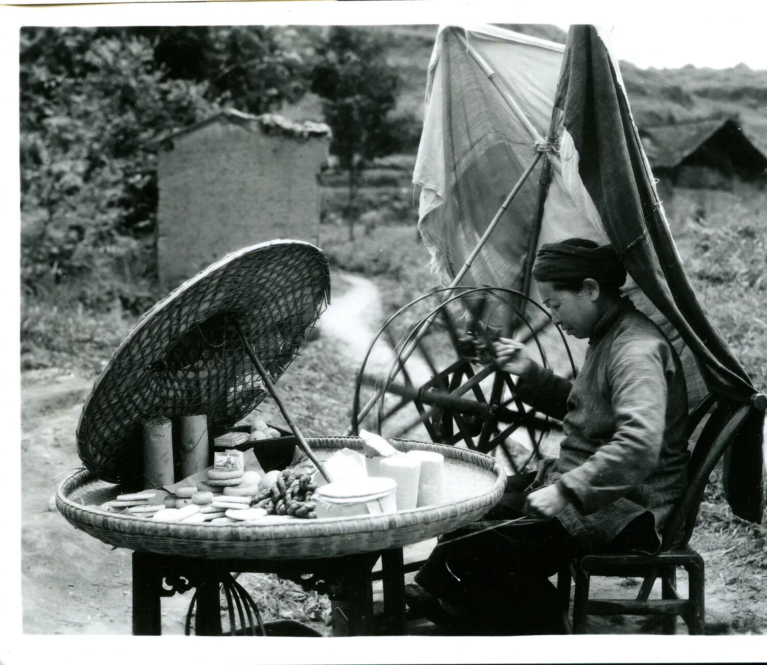 Roadside Vendor with Spinning Wheel and Woven Goods Tray, China-Burma Theater, WWII Era