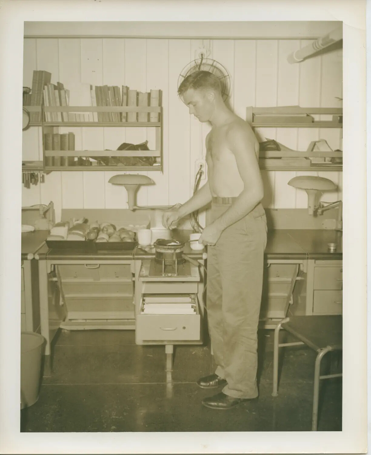 Sailor Cooking on Improvised Hot Plate Aboard USS Petrof Bay (CVE-80)
