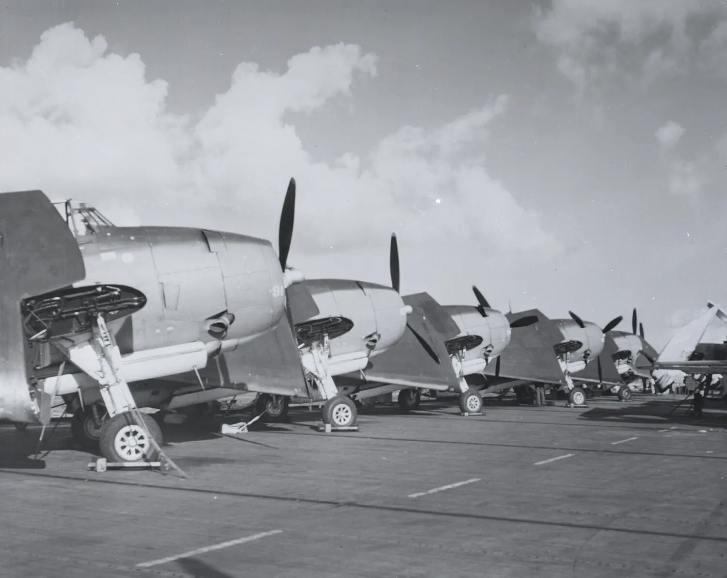 Row of Folded-Wing Carrier Aircraft on Flight Deck, USS Petrof Bay (CVE-80), WWII Era
