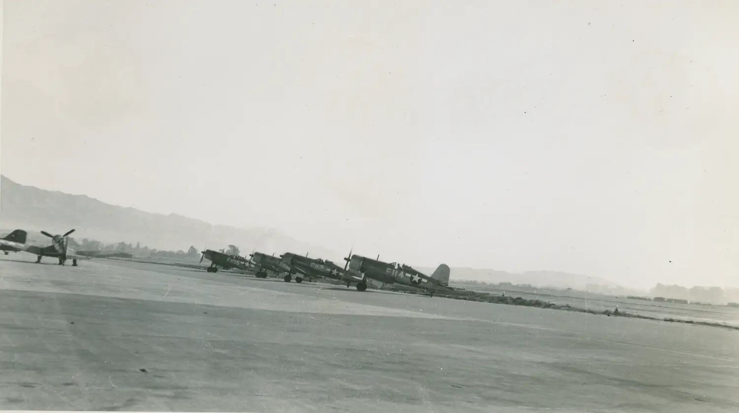 Line of F4U Corsair Fighters on Flight Line, Korean War Era Airfield