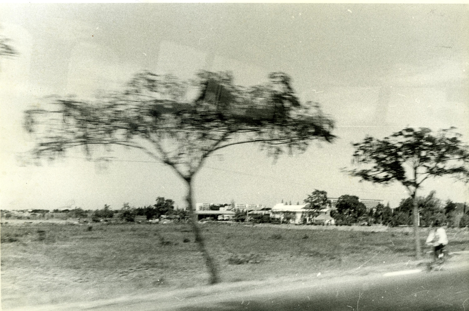 Blurred Roadside View of Phnom Penh's Outskirts