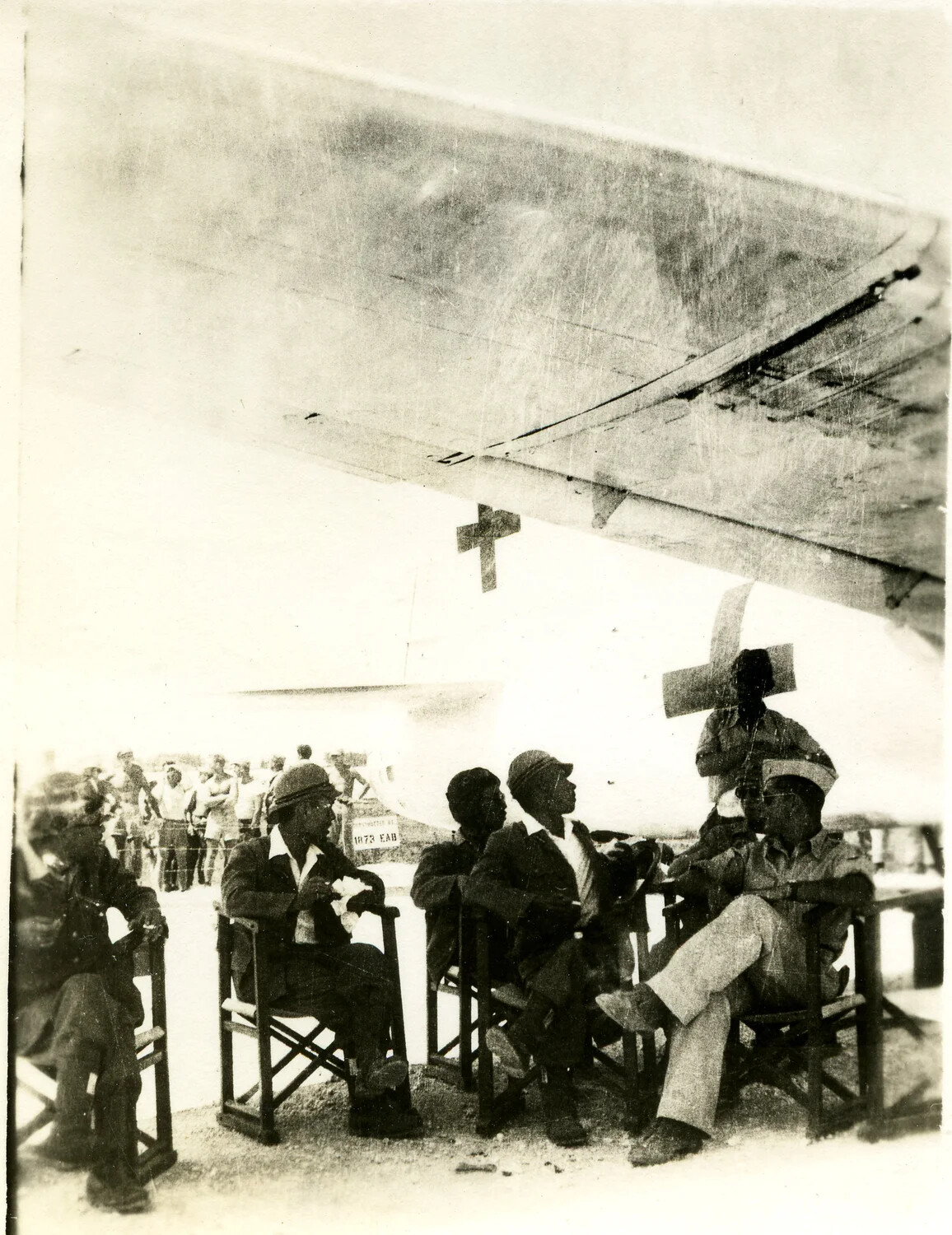 Airmen Resting Beneath Aircraft Wing with Red Cross Marking, Ie Shima, WWII