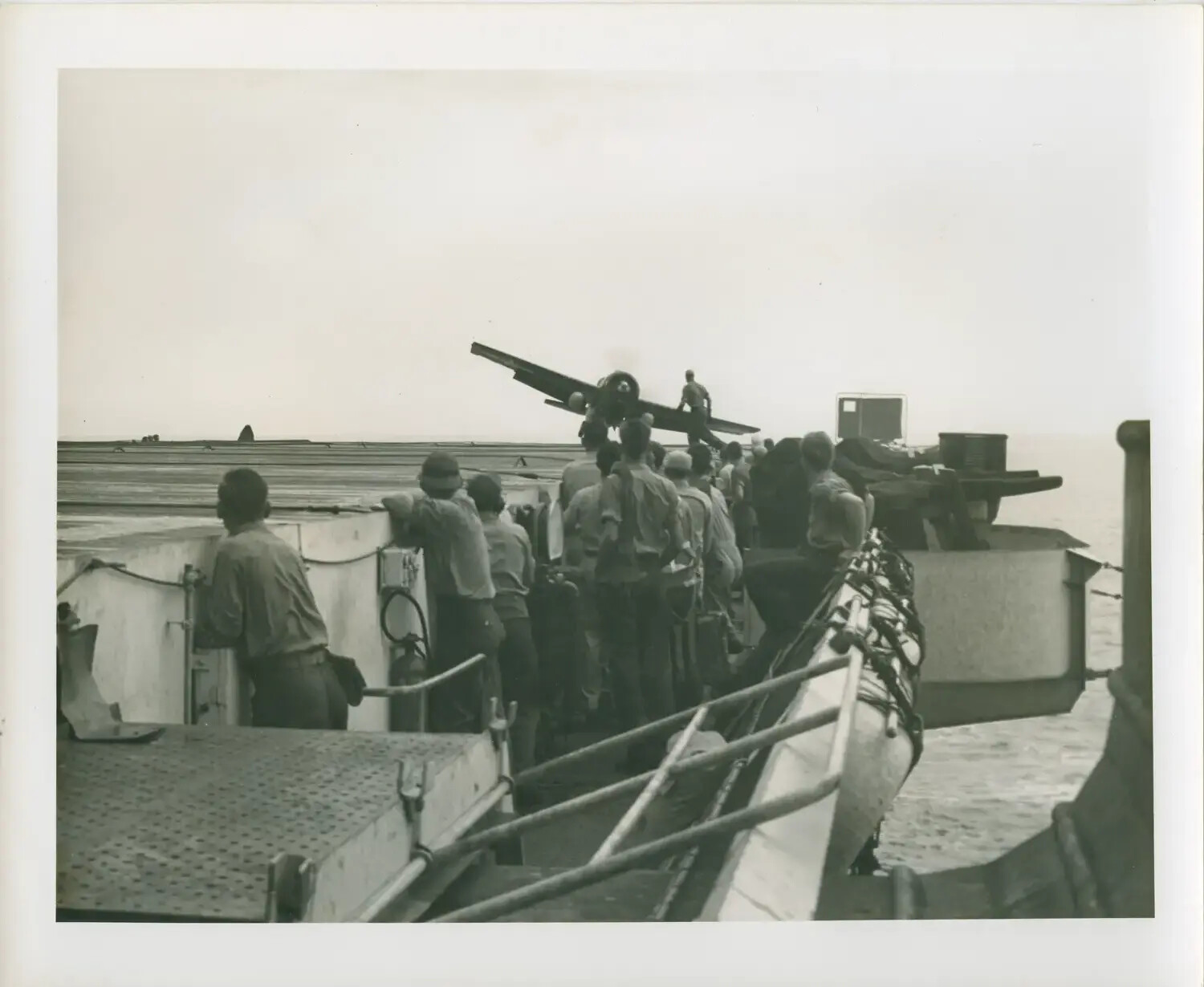 USS Petrof Bay (CVE-80): Sailors Observe Aircraft Nosed Over on Flight Deck, WWII