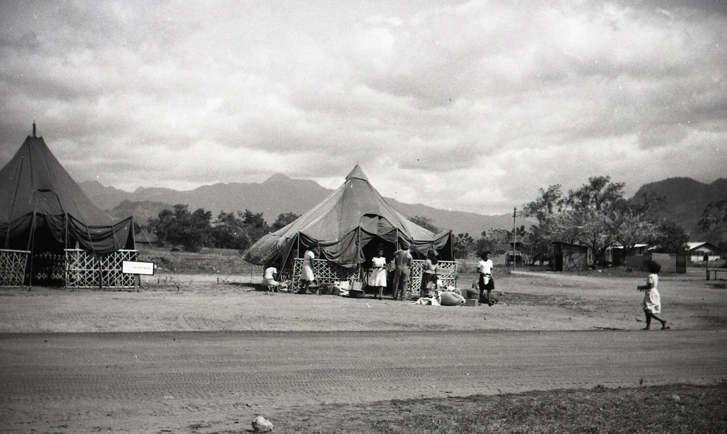 Tent Encampment with Civilians and Bamboo Structures, Luzon, Philippines, World War II Era