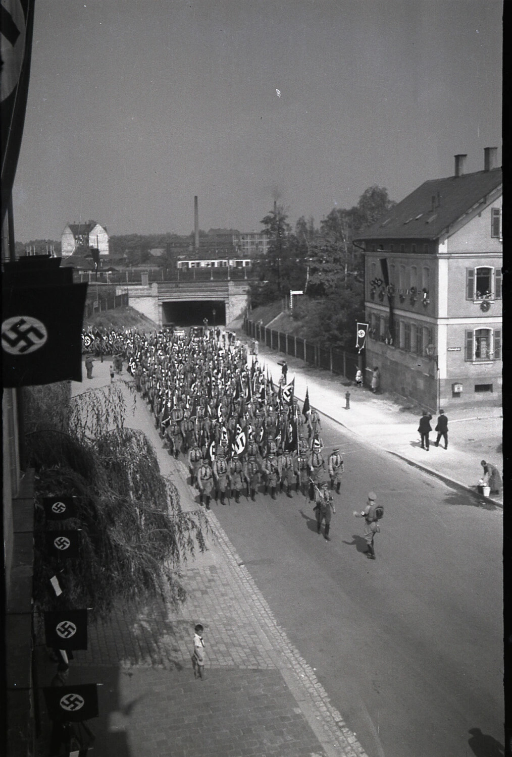 Nazi Party Formation Marching Through a German Town Street, 1930s