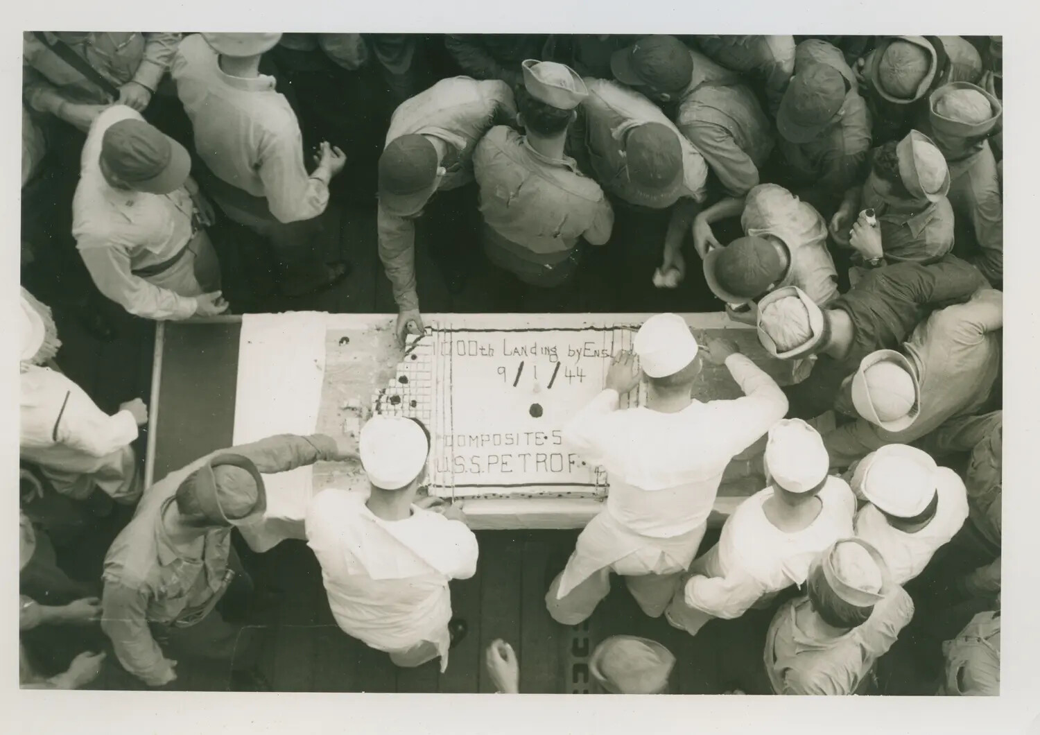 Sailors of USS Petrof Bay (CVE-80) Celebrate the 1,000th Deck Landing by Composite Squadron 5, 1 September 1944