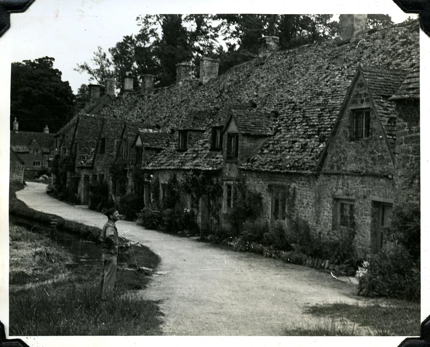U.S. Serviceman Viewing a Row of Stone Cottages in an English Village