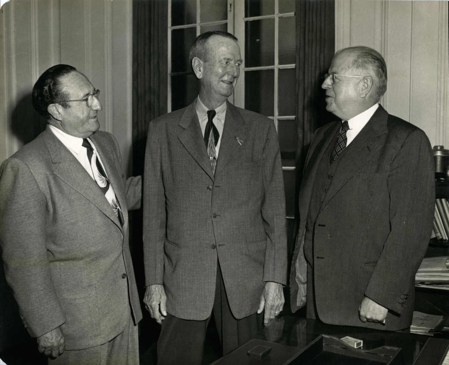 General Jonathan M. Wainwright IV in Civilian Dress with Two Men, Office Setting, c. 1949