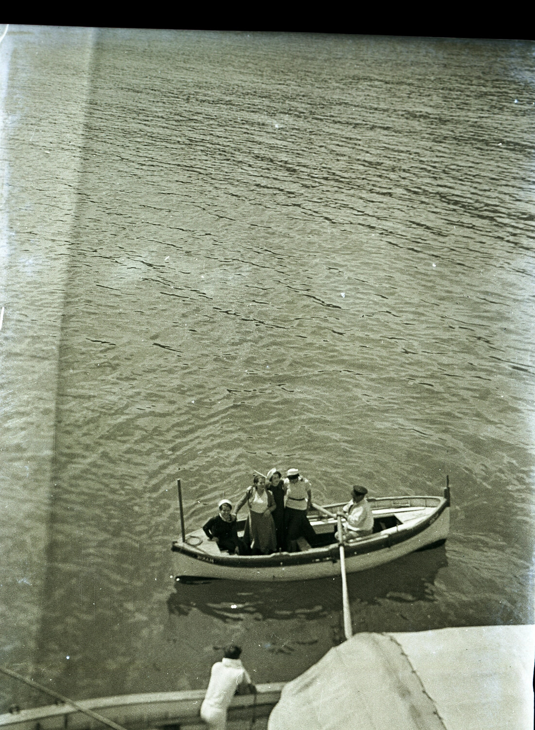 US Navy Sailors and Civilian Women in Small Boat, Viewed from Ship's Deck, China, 1930s