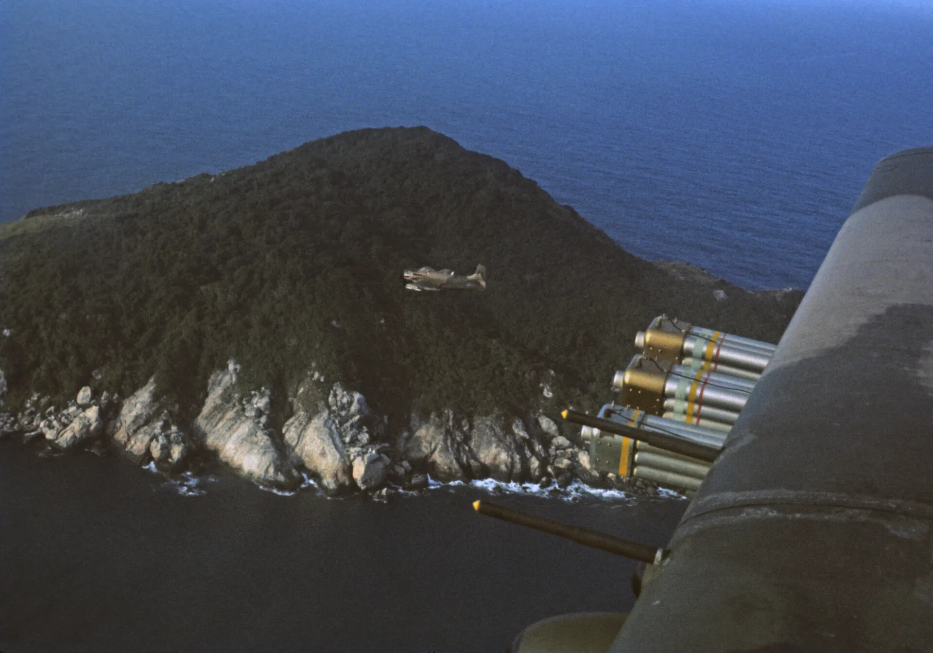 A-1 Skyraider Over Forested Ridge, Wingman View With Armament