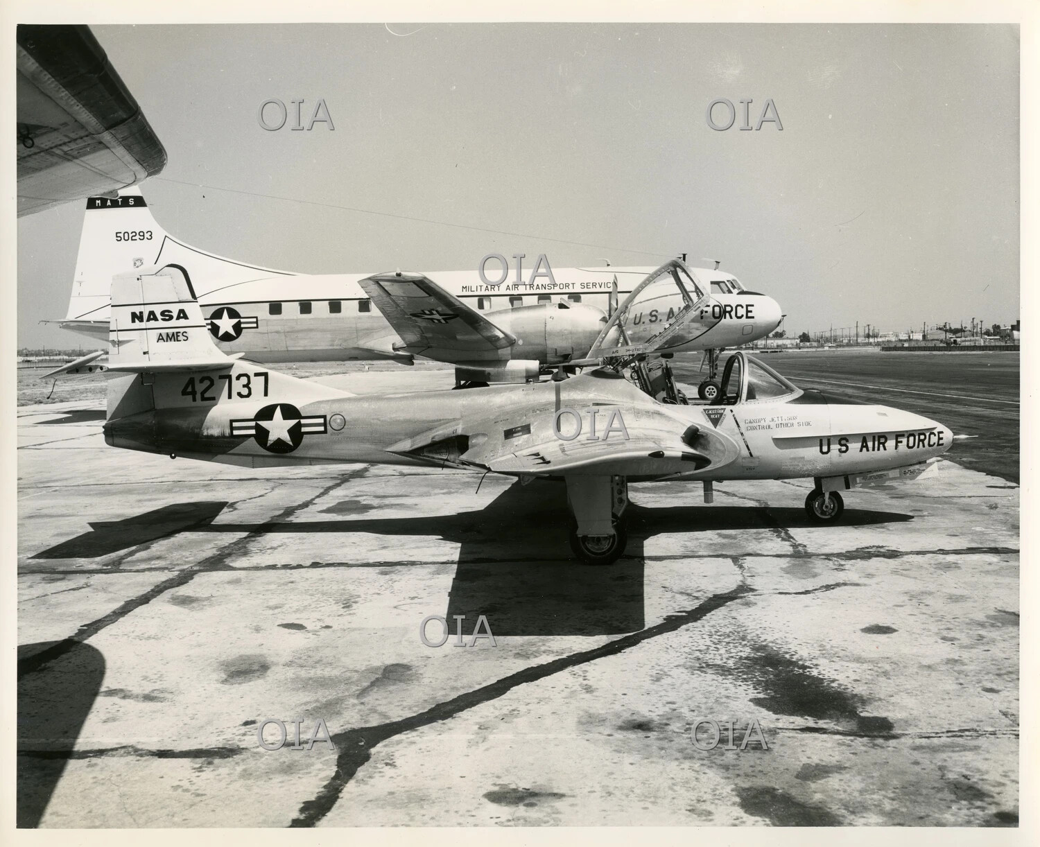 USAF Jet Trainer Aircraft (Tail No. 42737) on Ramp with NASA Ames and MATS Aircraft, Background